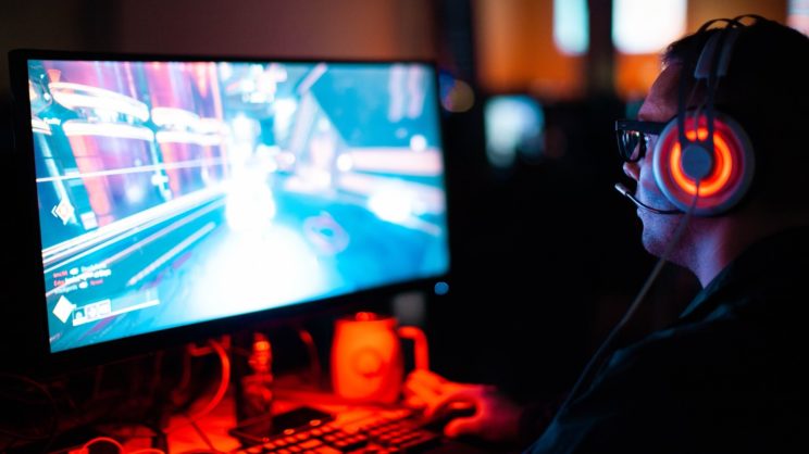 A person playing a game with a headset to communicate with their team