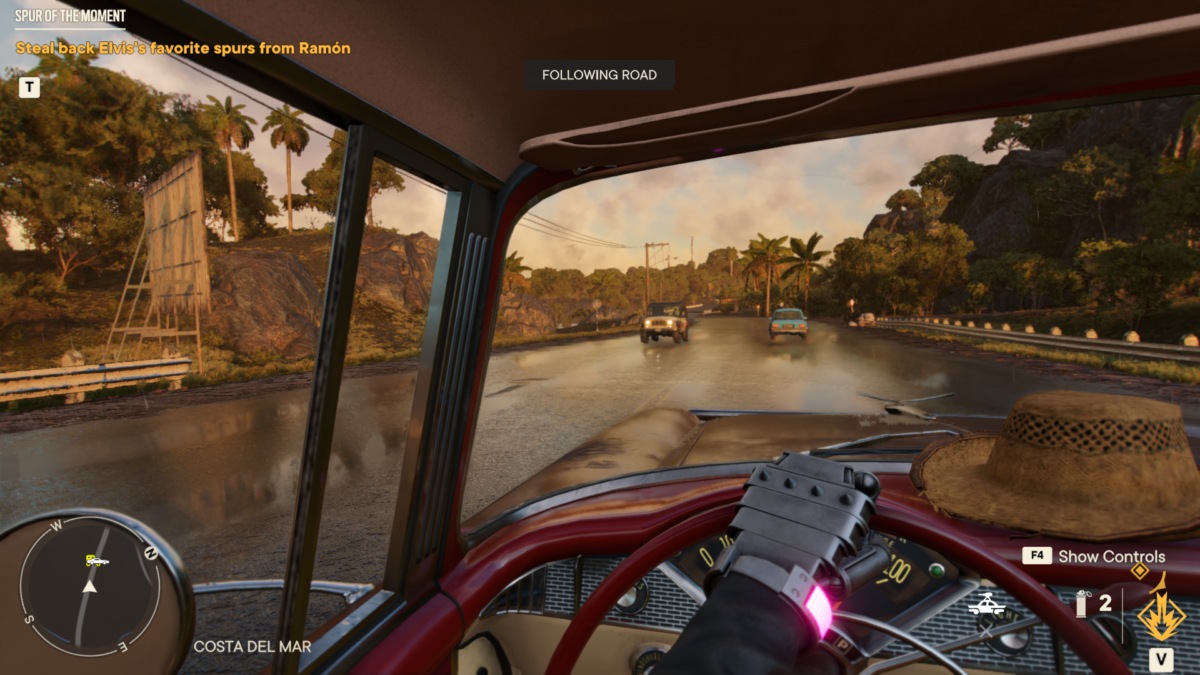 Dani driving a car in first person view, going down a road using the autodrive feature. There are some cars coming in both directions.