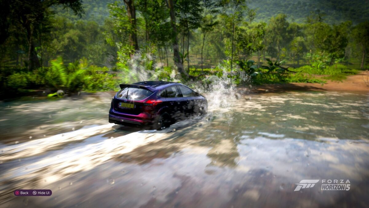 Screenshot from Forza Horizon 5, showing my favourite Ford Focus RS splashing through a river)