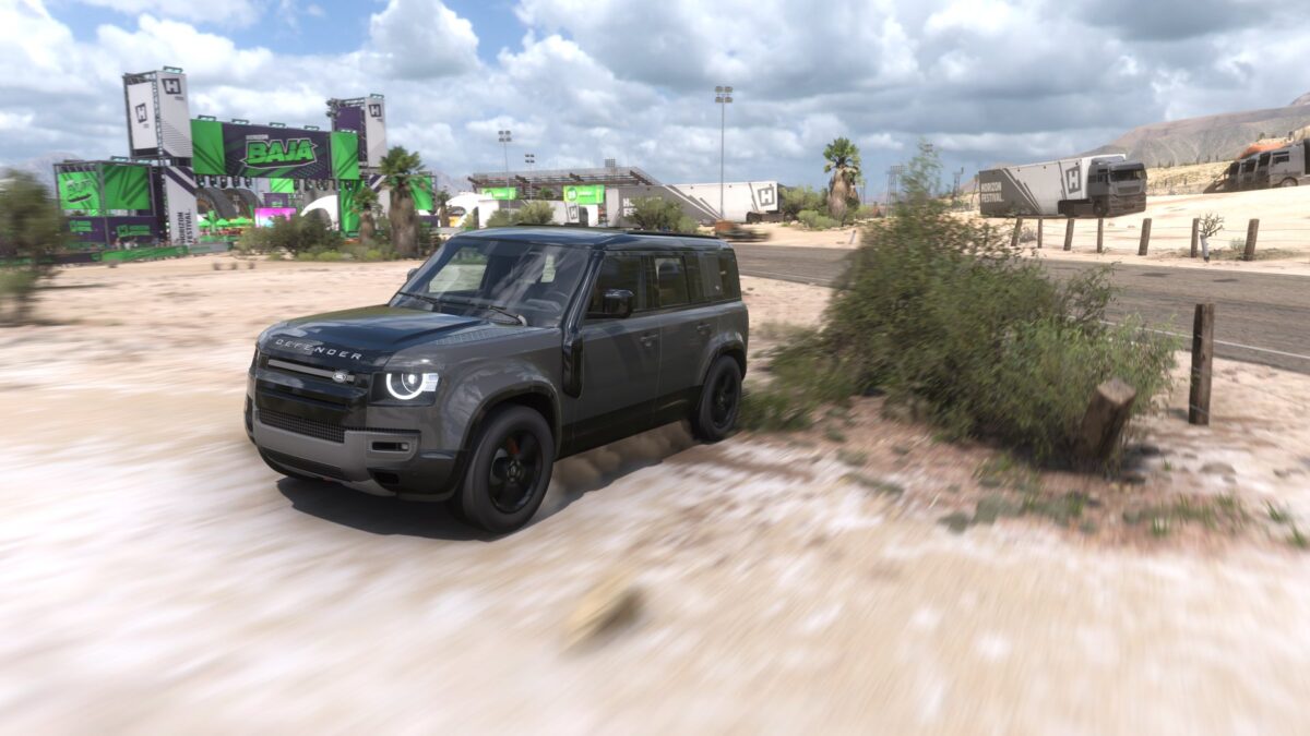 Screenshot from Forza Horizon 5, showing a Land Rover Defender outside the Horizon Festival.