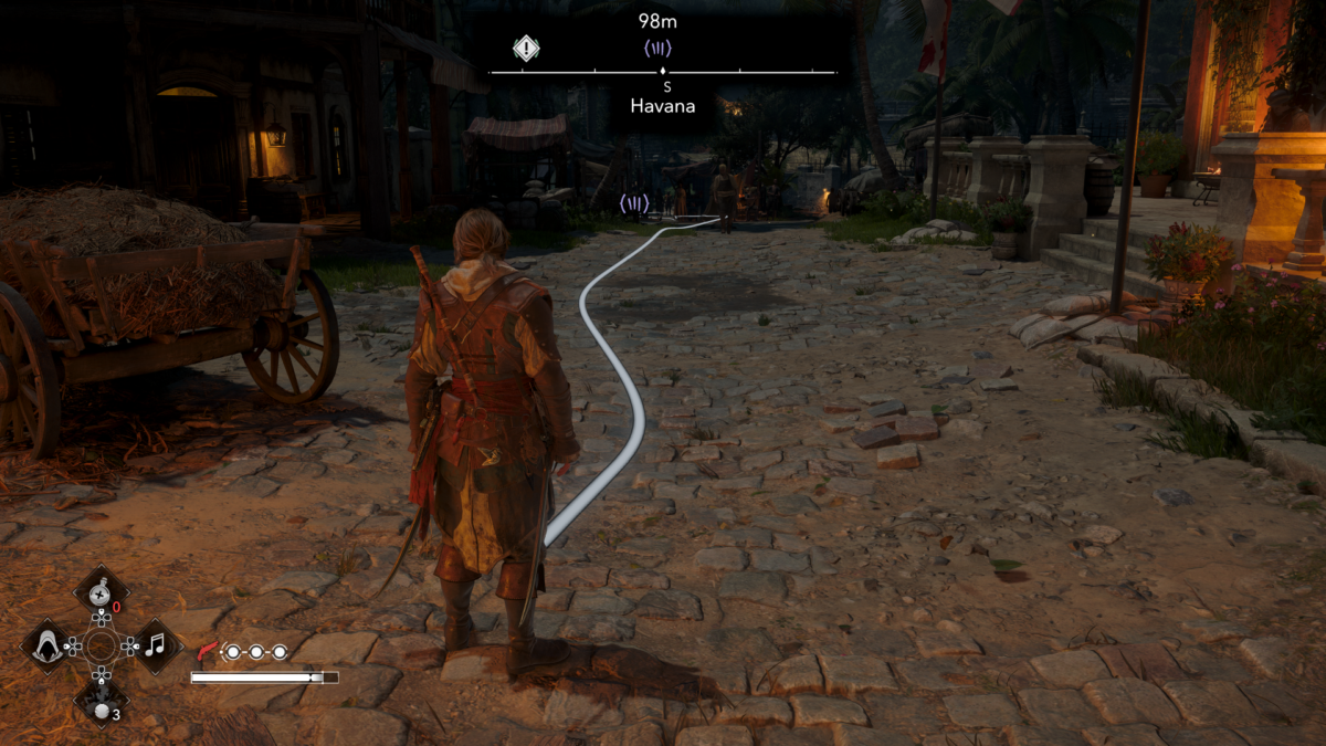 Third-person gameplay screenshot showing the Pathfinder navigation line active on the same cobbled street at night. The environment is dark and the white guideline stands out sharply against the road.